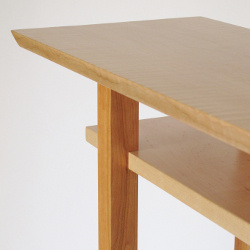 Lovely contrasting cherry is paired with the light blonde wood color of tiger maple for a unique look. This handmade modern wood table is the perfect narrow console table for small spaces